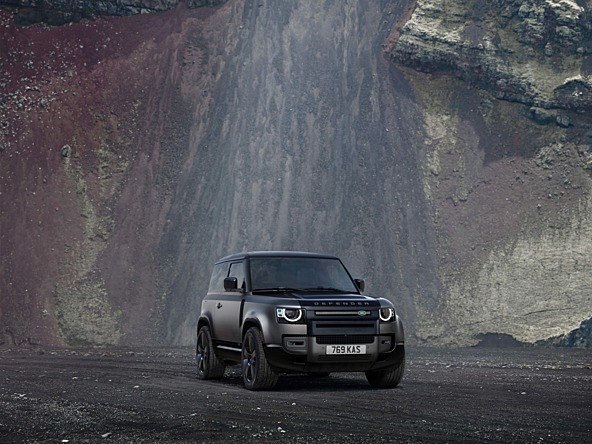 Land Rover driving with waterfall in the background